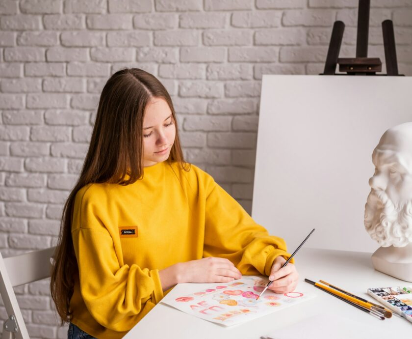 teen girl drawing in art studio