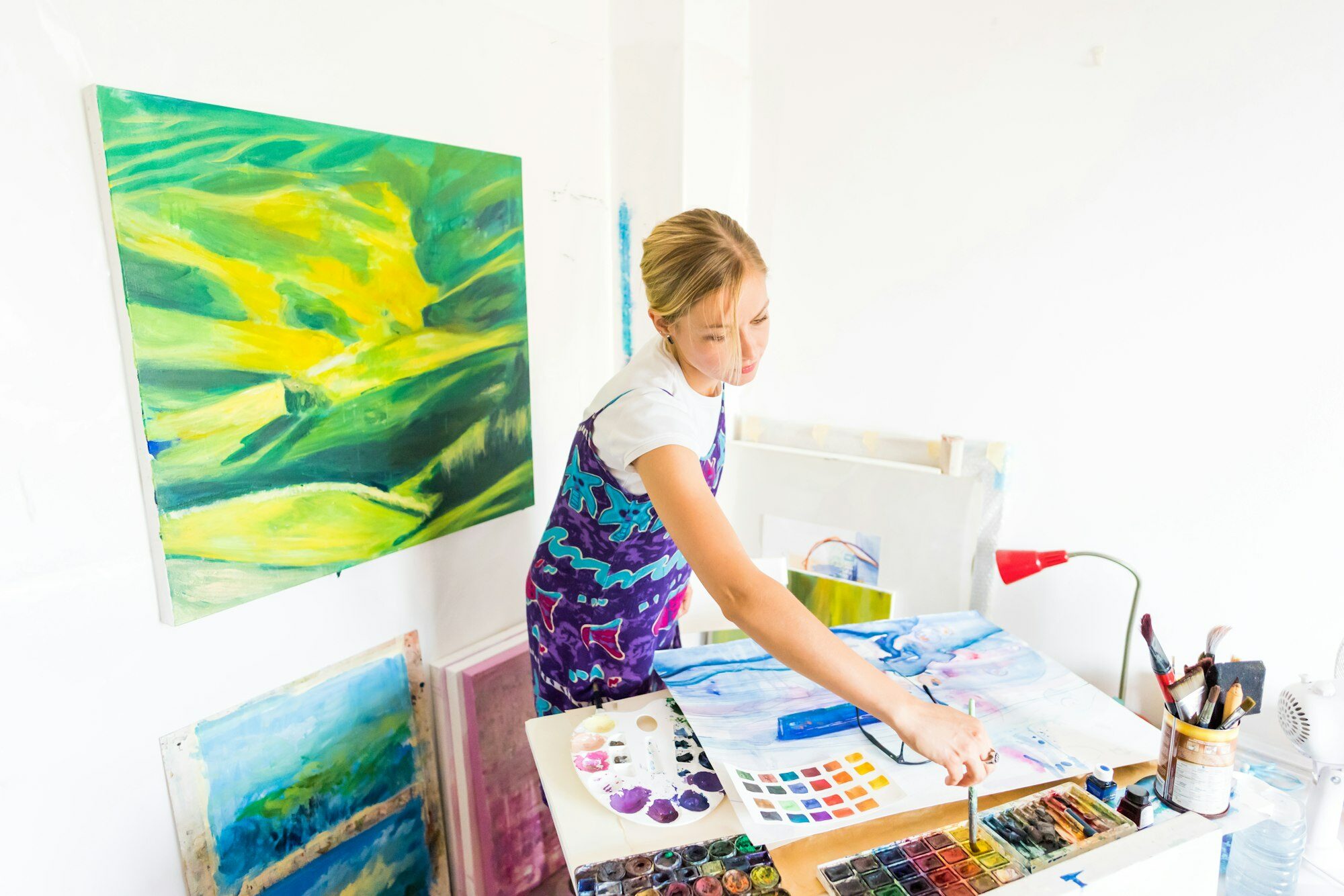 Young artist painter painting canvas studio gallery