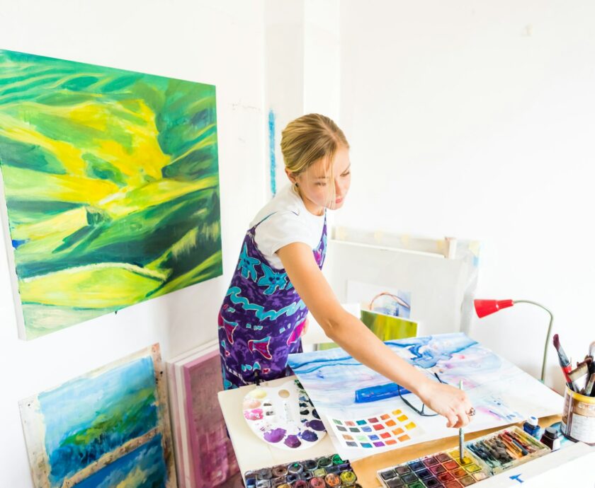 Young artist painter painting canvas studio gallery